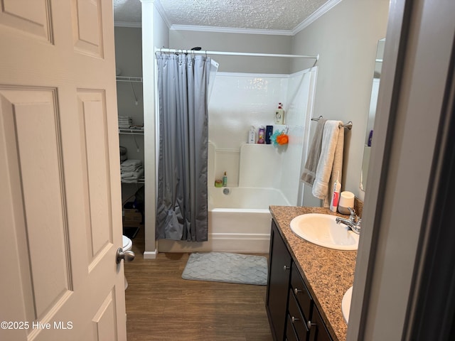 bathroom featuring crown molding, wood finished floors, a textured ceiling, and vanity