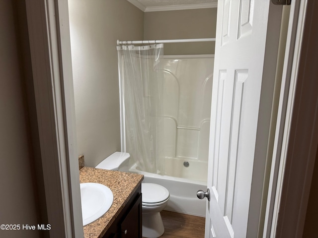 bathroom featuring shower / tub combo, toilet, ornamental molding, wood finished floors, and vanity