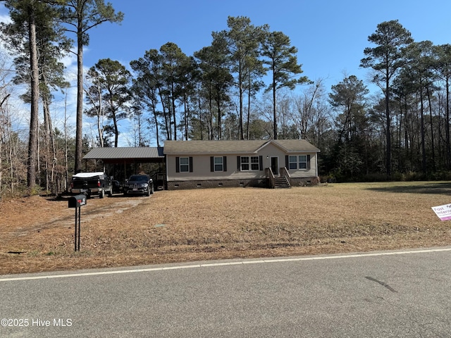 manufactured / mobile home featuring a carport, a front yard, crawl space, and driveway