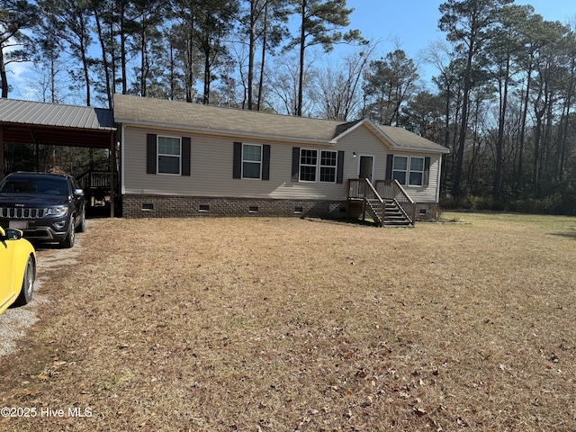 manufactured / mobile home with crawl space, an attached carport, and a front yard