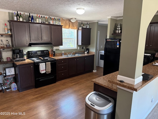 kitchen featuring extractor fan, dark brown cabinetry, wood finished floors, a sink, and black appliances