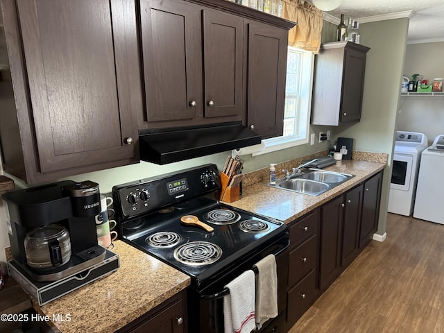 kitchen featuring washing machine and clothes dryer, extractor fan, dark brown cabinets, black electric range, and a sink