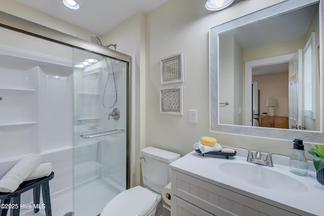 full bath with toilet, a shower stall, and vanity