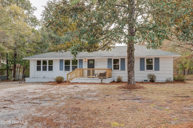 ranch-style house with crawl space, fence, and roof with shingles