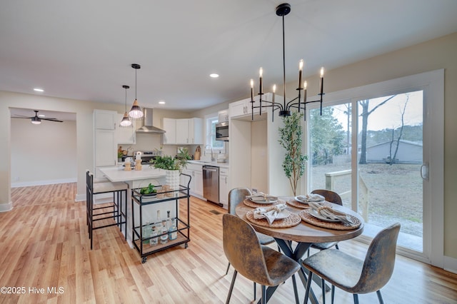 dining room featuring a wealth of natural light, light wood-type flooring, baseboards, and recessed lighting