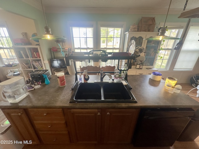 kitchen with a sink, decorative light fixtures, dishwasher, and ornamental molding