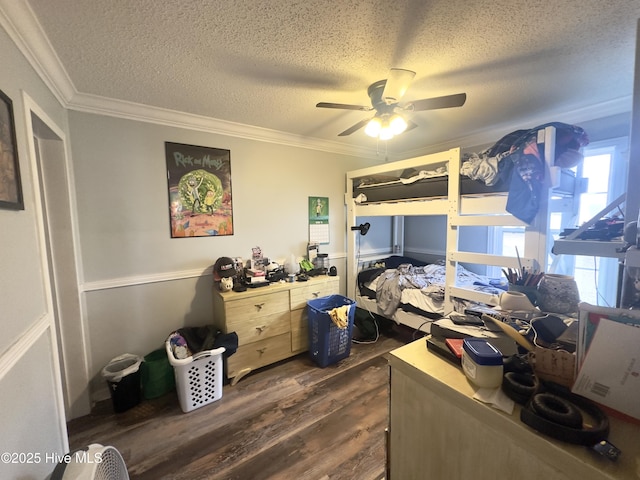 bedroom with ceiling fan, dark wood-type flooring, ornamental molding, and a textured ceiling