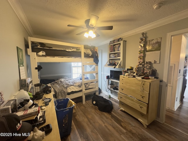 bedroom with a textured ceiling, dark wood-type flooring, ceiling fan, and ornamental molding