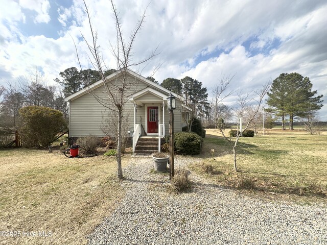 bungalow-style home featuring a front yard