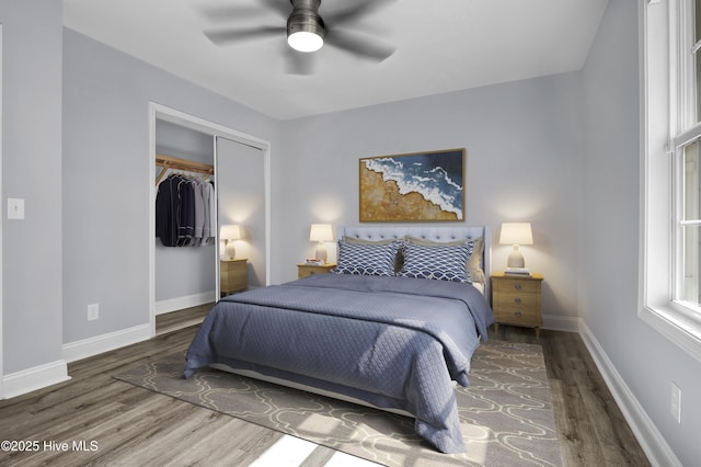 bedroom featuring a closet, wood finished floors, a ceiling fan, and baseboards