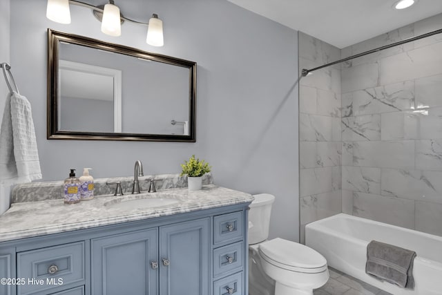 bathroom featuring toilet, tub / shower combination, and vanity