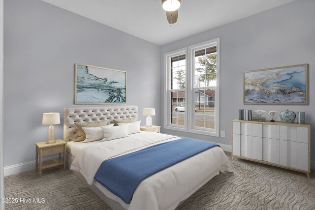 carpeted bedroom featuring ceiling fan and baseboards