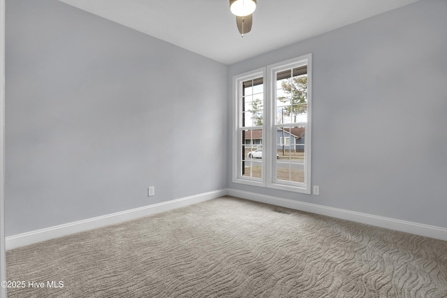 empty room featuring carpet, ceiling fan, and baseboards