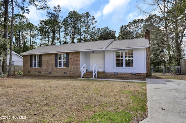 ranch-style home featuring a chimney, a shingled roof, a front yard, crawl space, and fence