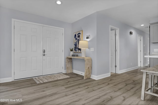 entrance foyer featuring recessed lighting, baseboards, and wood finished floors