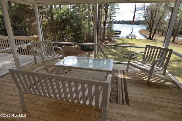 wooden terrace featuring a yard and a water view