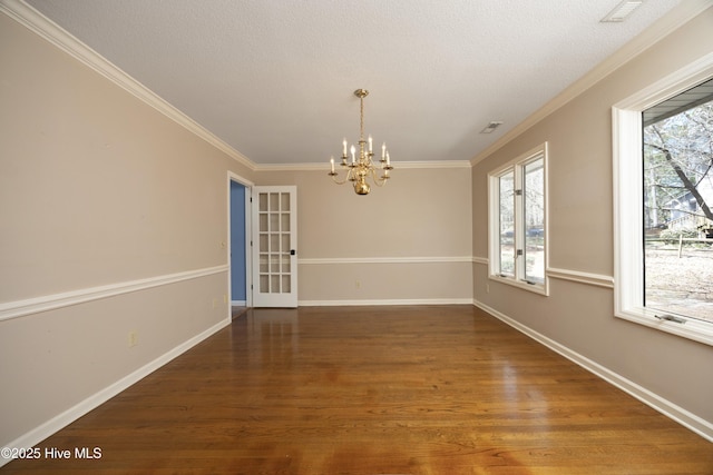 unfurnished dining area with crown molding, wood finished floors, and baseboards