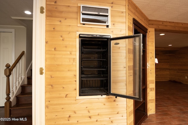 details featuring wooden walls, recessed lighting, and ornamental molding