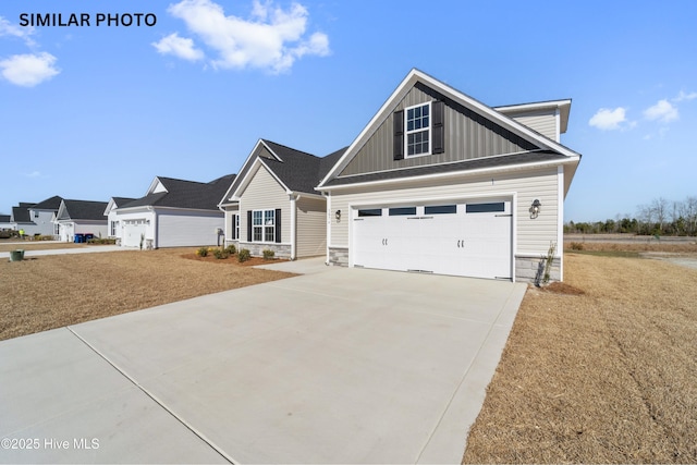 craftsman house with board and batten siding, concrete driveway, a garage, and stone siding