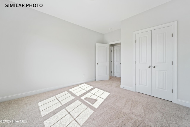 unfurnished bedroom featuring a closet, baseboards, and carpet