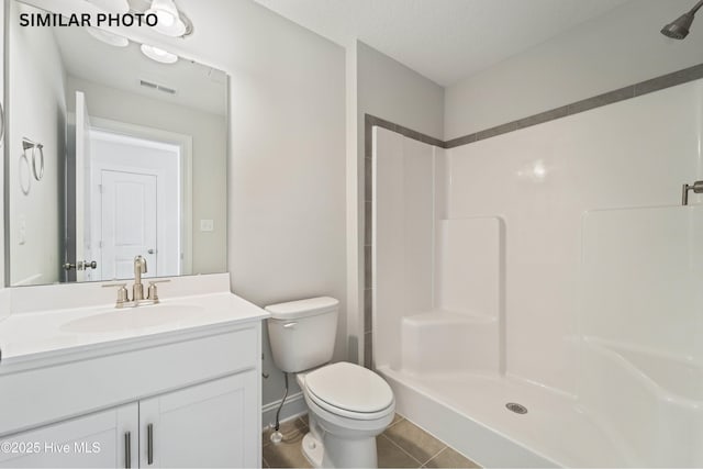 bathroom featuring visible vents, vanity, toilet, and a shower