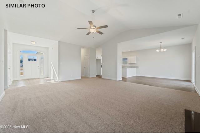 unfurnished living room with visible vents, light carpet, ceiling fan with notable chandelier, baseboards, and vaulted ceiling