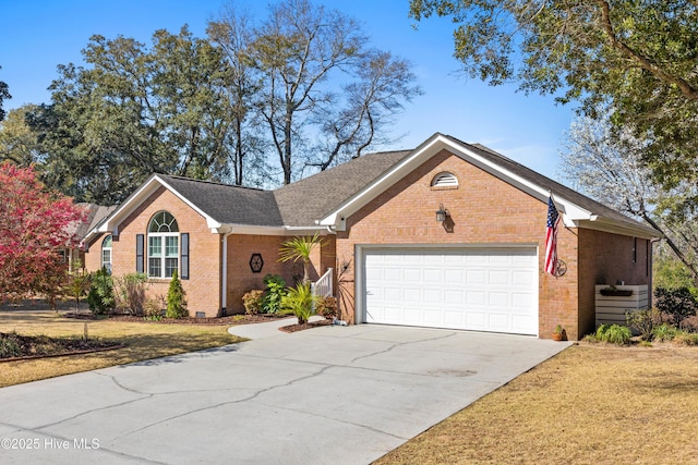 ranch-style home featuring brick siding, an attached garage, concrete driveway, and a front yard