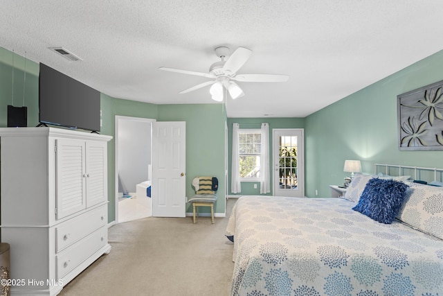 carpeted bedroom with visible vents, baseboards, a textured ceiling, and ceiling fan