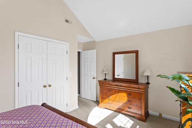 carpeted bedroom featuring baseboards, visible vents, a closet, and high vaulted ceiling