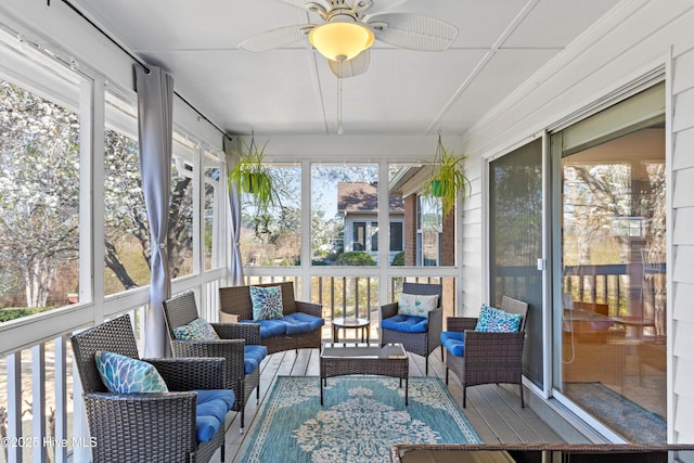 sunroom featuring a ceiling fan