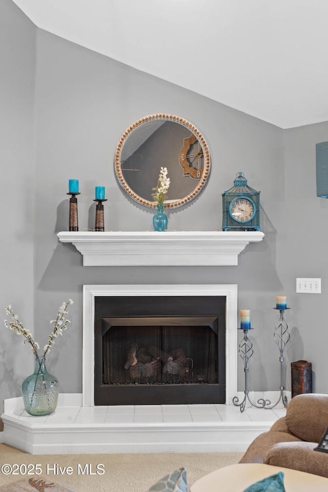 interior details with a fireplace with raised hearth