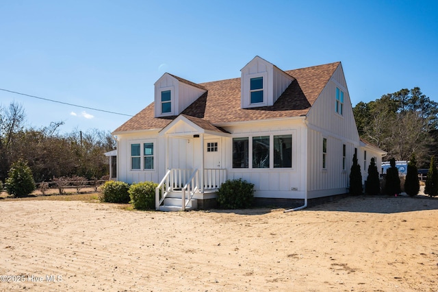 view of front of property with board and batten siding and roof with shingles