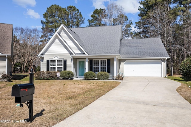 traditional-style home with a garage, driveway, a front lawn, and a shingled roof