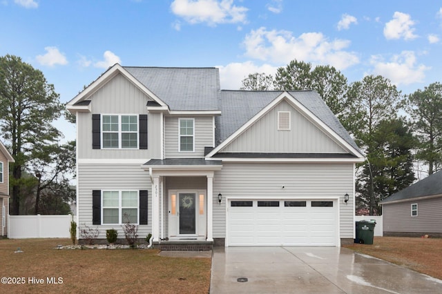 view of front of property with board and batten siding, a shingled roof, fence, a front yard, and driveway