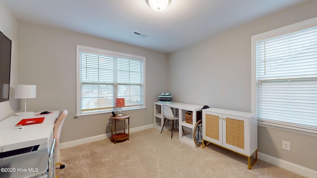 office space with light carpet, baseboards, and visible vents