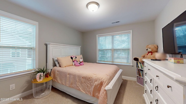 bedroom with light carpet, visible vents, and baseboards