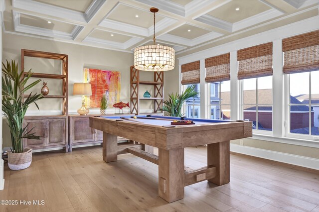 recreation room with a healthy amount of sunlight, light wood-type flooring, and beam ceiling