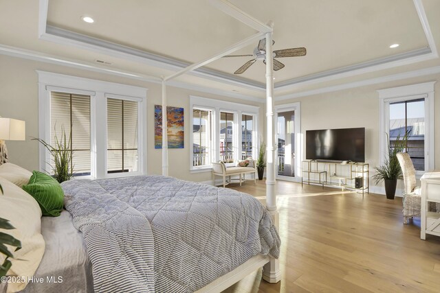 bedroom featuring crown molding, wood finished floors, a raised ceiling, and recessed lighting