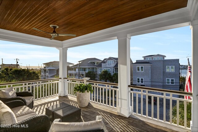 wooden terrace with a residential view and ceiling fan