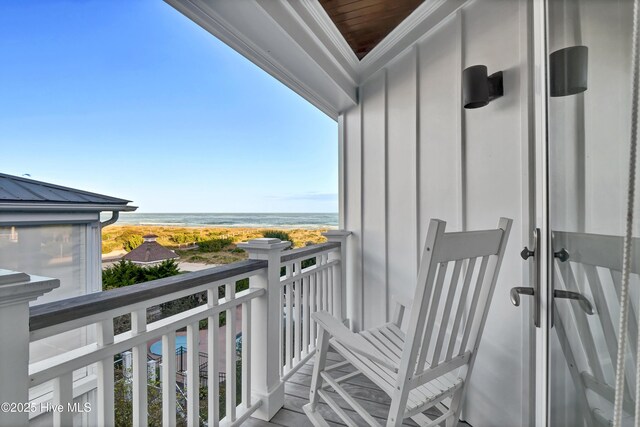 balcony with a view of the beach and a water view