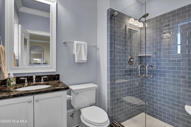 full bathroom with a stall shower, vanity, and toilet