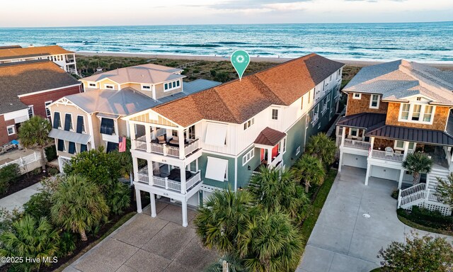 bird's eye view with a water view, a residential view, and a beach view