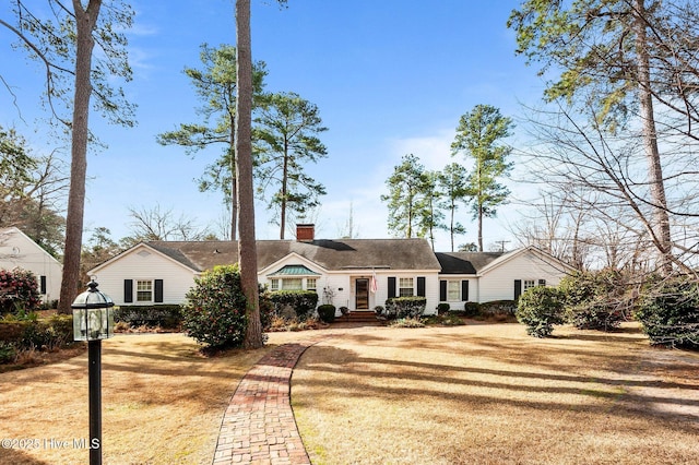 view of front of property with a front yard and a chimney