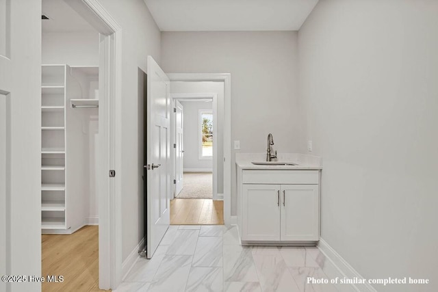 interior space featuring a sink and baseboards