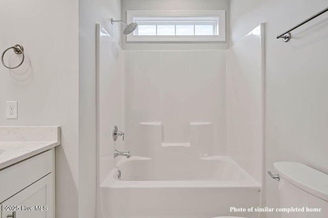 full bath with  shower combination, vanity, and toilet