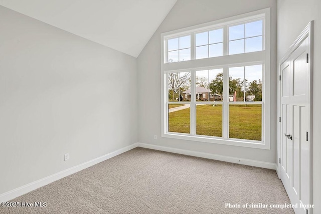 interior space featuring high vaulted ceiling, baseboards, and carpet flooring