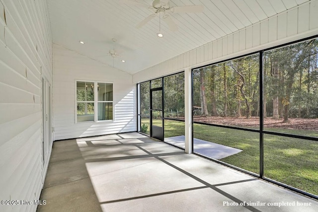 unfurnished sunroom featuring a ceiling fan and vaulted ceiling