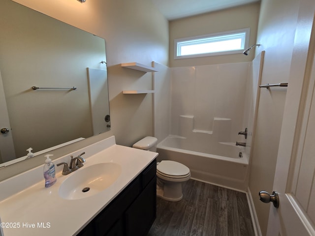 bathroom with  shower combination, vanity, toilet, and wood finished floors