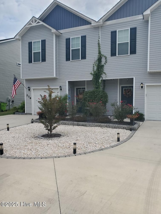 view of front of home featuring board and batten siding, driveway, and an attached garage