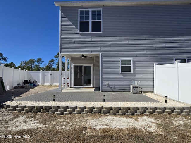 rear view of house featuring a patio area, a fenced backyard, a gate, and ceiling fan